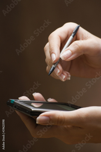Photo: Woman using PDA Woman using PDA