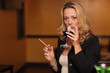 Photo: Woman drinking wine and smoking a cigar Woman drinking wine and smoking a cigar