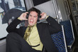 Businessman listening to headphones on a train