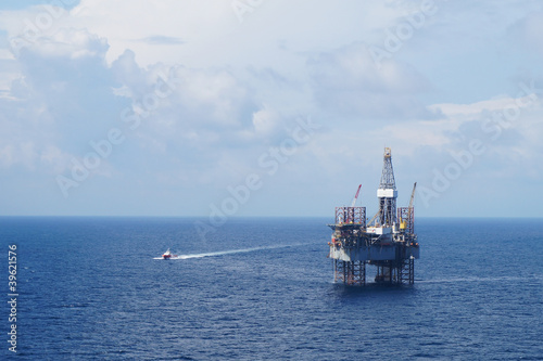 Photo: Jack up drilling rig and crew boat in the middle of the sea Jack up drilling rig and crew boat in the middle of the sea
