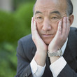 Senior Asian businessman in thinking pose