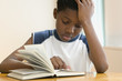 African American boy reading book