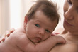 Portrait of baby resting on his mother