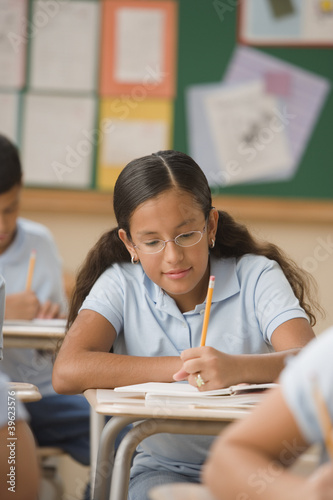 Photo: Student writing in class Student writing in class