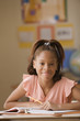 Student smiling from her desk