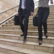 Blurred view of business people's legs descending stairs