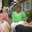 Young women relaxing together with wine