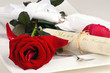 Romantic place setting with red rose and menu-card