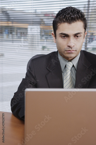 Photo: Businessman working at his desk Businessman working at his desk