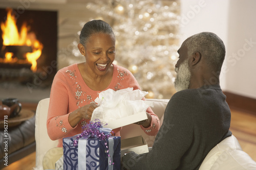 Photo: Senior African couple opening presents Senior African couple opening presents