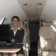 Businesswoman working on laptop inside airplane