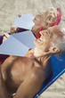 Senior couple sunning themselves at the beach