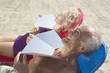 Senior couple sunning themselves at the beach
