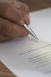 Close up of man signing document