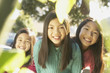 Three young Asian sisters smiling outdoors