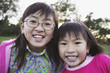 Young Asian sisters in the countryside