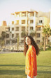 Hispanic woman in the sunlight at a resort hotel