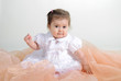 The small beautiful girl lies on a white background