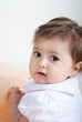 The small beautiful girl lies on a white background