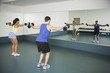 Man and woman lifting weights at gym