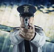 Male police officer aiming gun