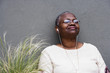 Middle-aged African woman listening to music with earphones
