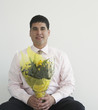 Businessman holding bouquet of flowers