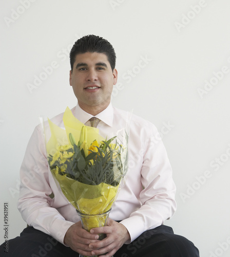 Photo: Businessman holding bouquet of flowers Businessman holding bouquet of flowers