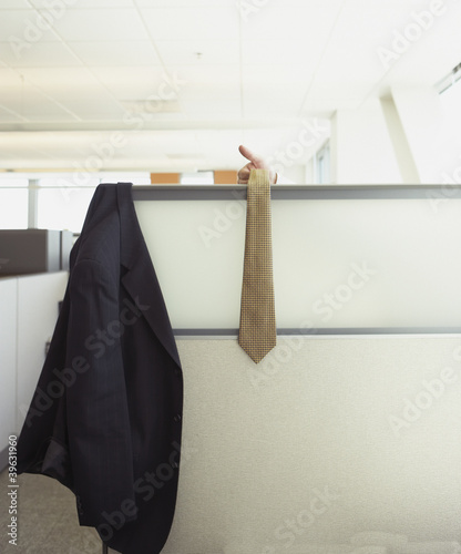 Photo: Suit jacket and tie hanging over cubicle wall Suit jacket and tie hanging over cubicle wall