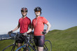 Asian couple with bicycles in countryside