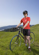 Asian woman wearing bicycle gear with bicycle