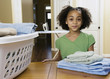African girl with folded laundry