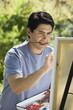 Man painting with easel outdoors