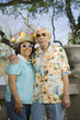 "Senior couple wearing sunglasses, straw hat and Hawaiian shirt"