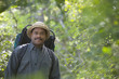 African man wearing backpack in woods