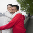 Asian couple hugging outdoors