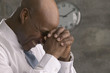 African businessman smiling and leaning head on hands