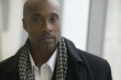 Close up of African man wearing overcoat and scarf