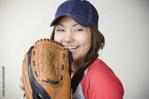 Photo: Hispanic woman smiling with baseball glove Hispanic woman smiling with baseball glove