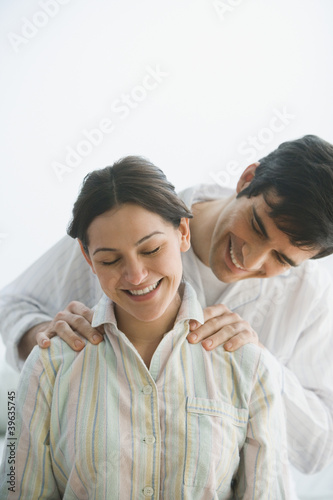 Photo: Hispanic man giving wife shoulder massage Hispanic man giving wife shoulder massage