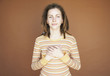 Young woman with hands on heart