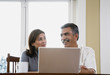 Middle-aged couple using laptop