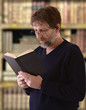 elderly man reading a book