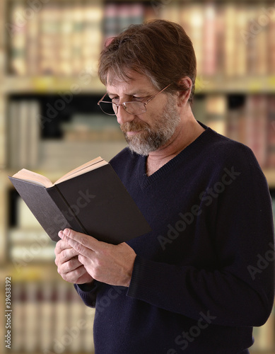 Photo: elderly man reading a book elderly man reading a book