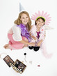 Studio shot of mother and daughter playing dress up