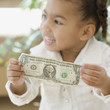 African girl holding dollar bill