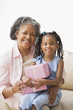 African grandmother and granddaughter hugging