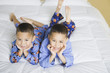 Portrait of African brothers on bed