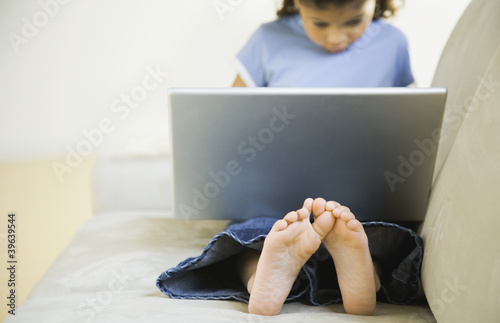 Photo: African girl looking at laptop African girl looking at laptop