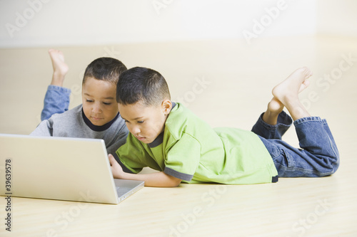 Photo: African brothers looking at laptop African brothers looking at laptop